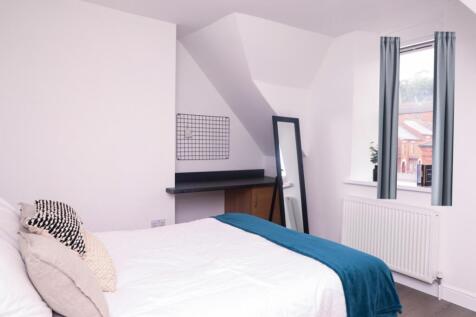 A bright and inviting double bedroom featuring ...