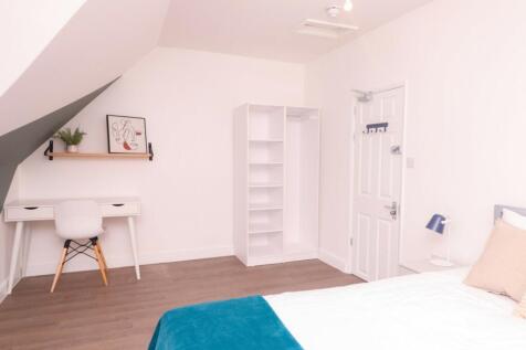 A bright and spacious double bedroom featuring ...