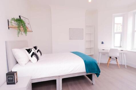 A bright and inviting double bedroom featuring ...
