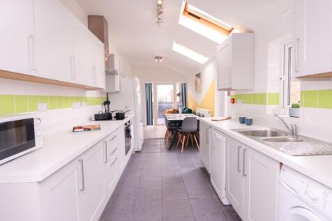A bright and modern kitchen featuring ample cou...