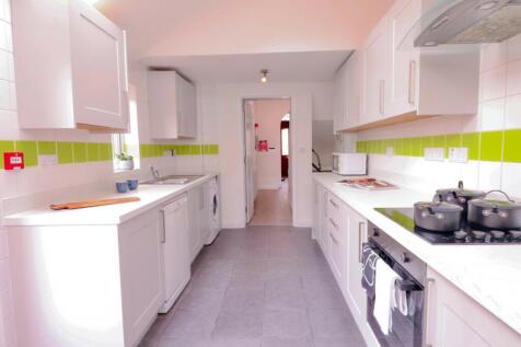 A bright and modern kitchen featuring sleek cab...