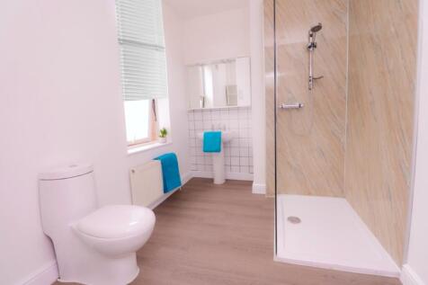 A bright and modern bathroom featuring a spacio...