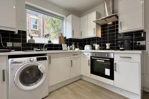 A modern and well-equipped kitchenette with amp...