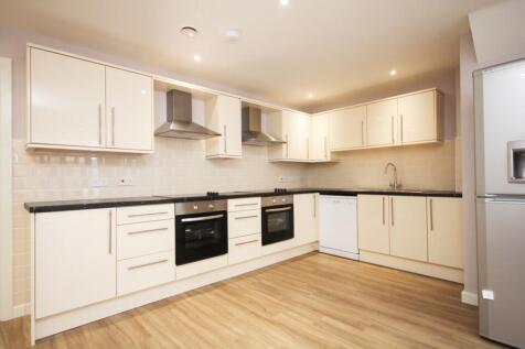 A modern and spacious kitchen with ample storag...
