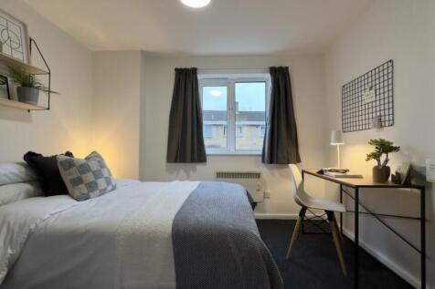 A bright and inviting double bedroom featuring ...