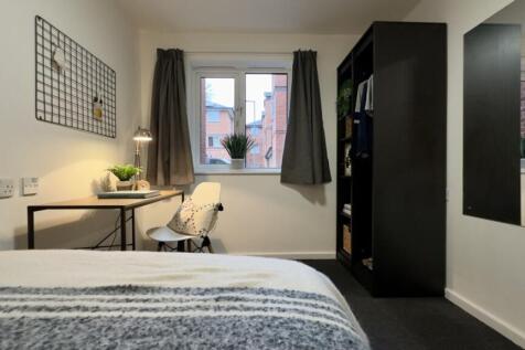 A bright and tidy double bedroom featuring a co...