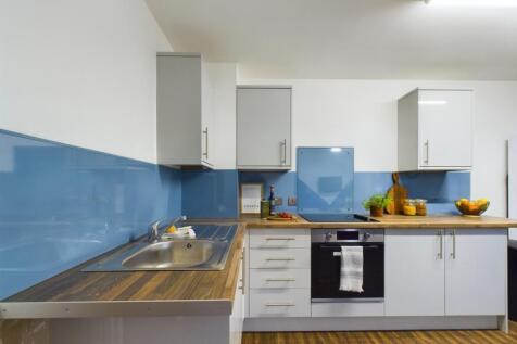 A bright and modern kitchen with ample storage ...