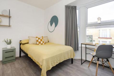 A bright and cozy double bedroom featuring a co...