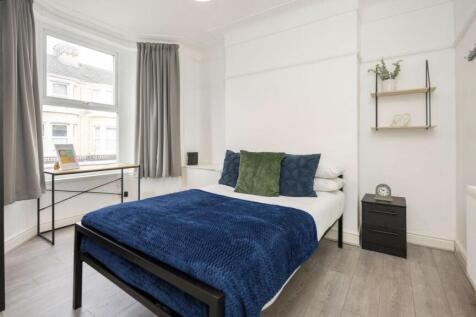 A bright and inviting double bedroom featuring ...