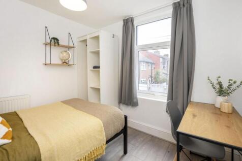 A bright and stylish double bedroom, featuring ...