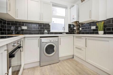 A modern and clean kitchenette with stylish bla...