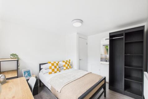 Bright, modern bedroom with a double bed, neutr...