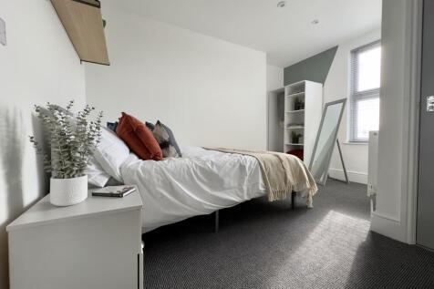 A spacious and inviting double bedroom featurin...