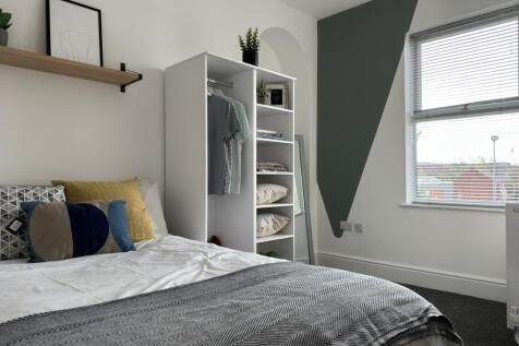 A bright and inviting double bedroom featuring ...