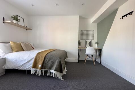 A bright and spacious double bedroom featuring ...
