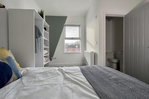 A bright and inviting double bedroom with moder...