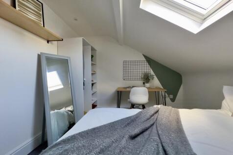 A bright and tidy double bedroom featuring a co...