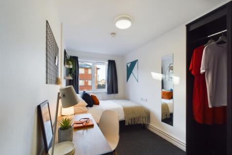 A bright and inviting double bedroom with ample...
