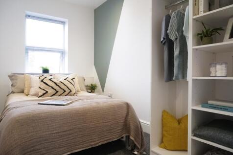 A stylish and well-lit double bedroom featuring...