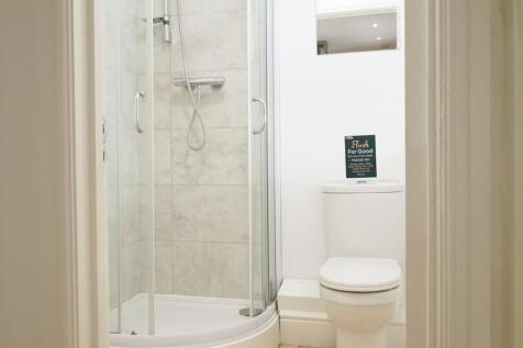 A clean and modern bathroom with a shower enclo...