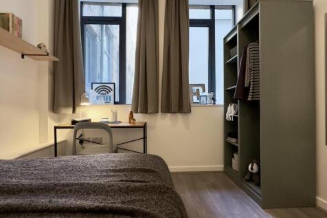 A stylish and well-lit double bedroom featuring...