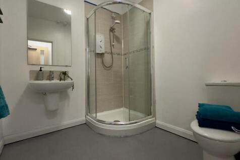 A modern and tidy bathroom featuring a spacious...