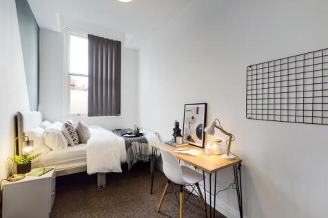 A stylish and inviting double bedroom with ampl...
