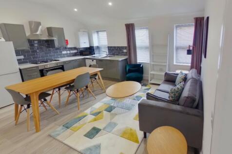 A bright and spacious living room featuring mod...