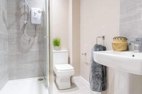 Bright, modern bathroom with a walk-in shower, ...