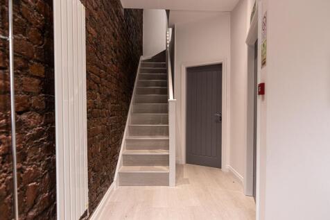 Well-finished interior stairwell with exposed b...