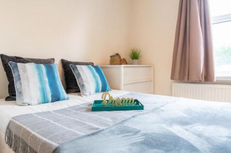 Bright, neatly styled bedroom with a double bed...