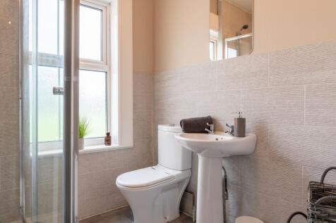 Bright, modern bathroom with a walk-in shower, ...