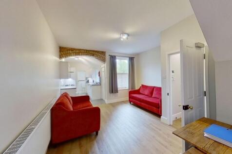 Bright furnished living room with two vibrant r...
