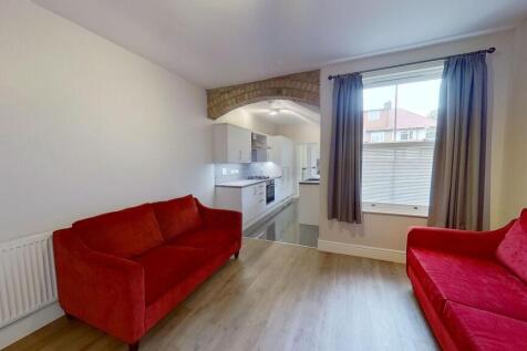 Bright, modern open-plan living room with large...