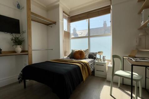 A bright and inviting double bedroom with ample...