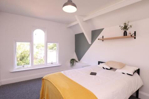 A bright and inviting double bedroom featuring ...
