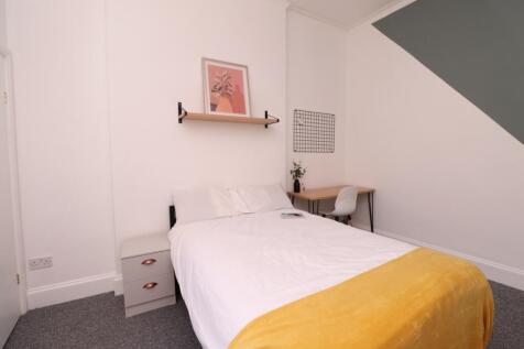 A bright and inviting double bedroom, featuring...
