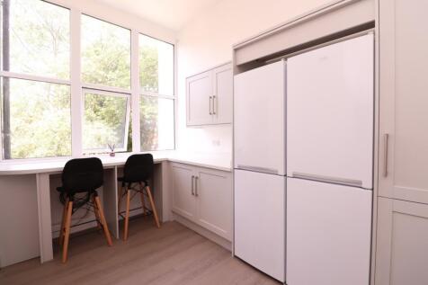 A bright and modern kitchenette featuring ample...