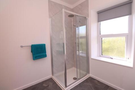 A modern and pristine bathroom featuring a spac...