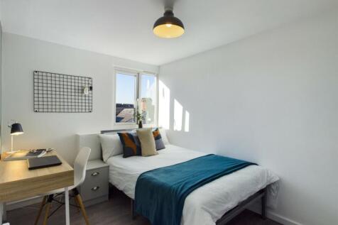 A bright and inviting double bedroom with moder...