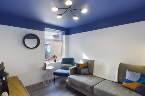 A bright and inviting living room featuring mod...