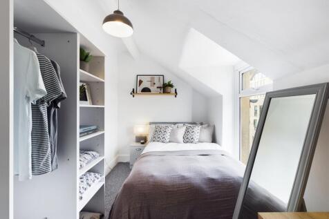 A bright and inviting double bedroom featuring ...