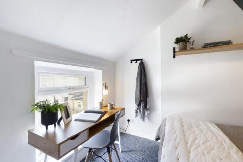 A bright and inviting double bedroom featuring ...