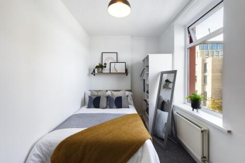 A bright and stylish double bedroom featuring m...