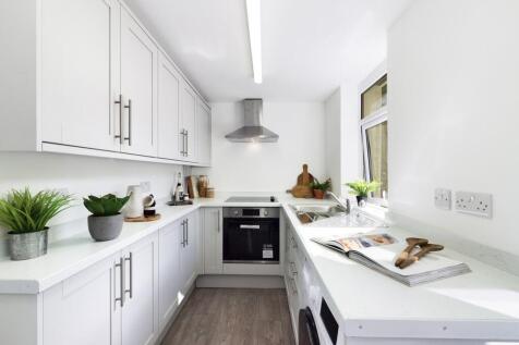 A bright and modern kitchen with ample storage ...