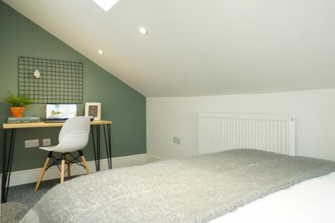 A bright and modern double bedroom featuring a ...