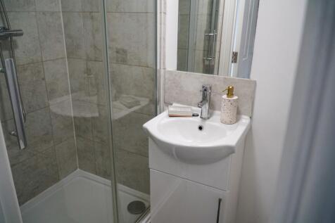 A modern and tidy bathroom featuring a spacious...