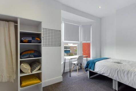 A bright and inviting double bedroom with ample...