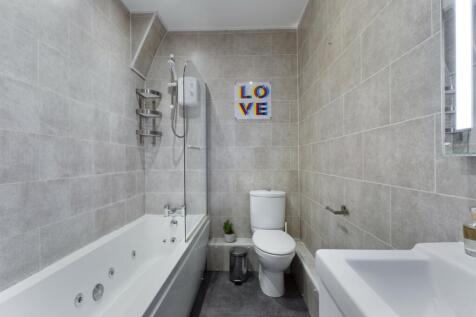 A spacious and modern bathroom featuring a styl...