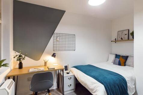 A bright and inviting double bedroom featuring ...